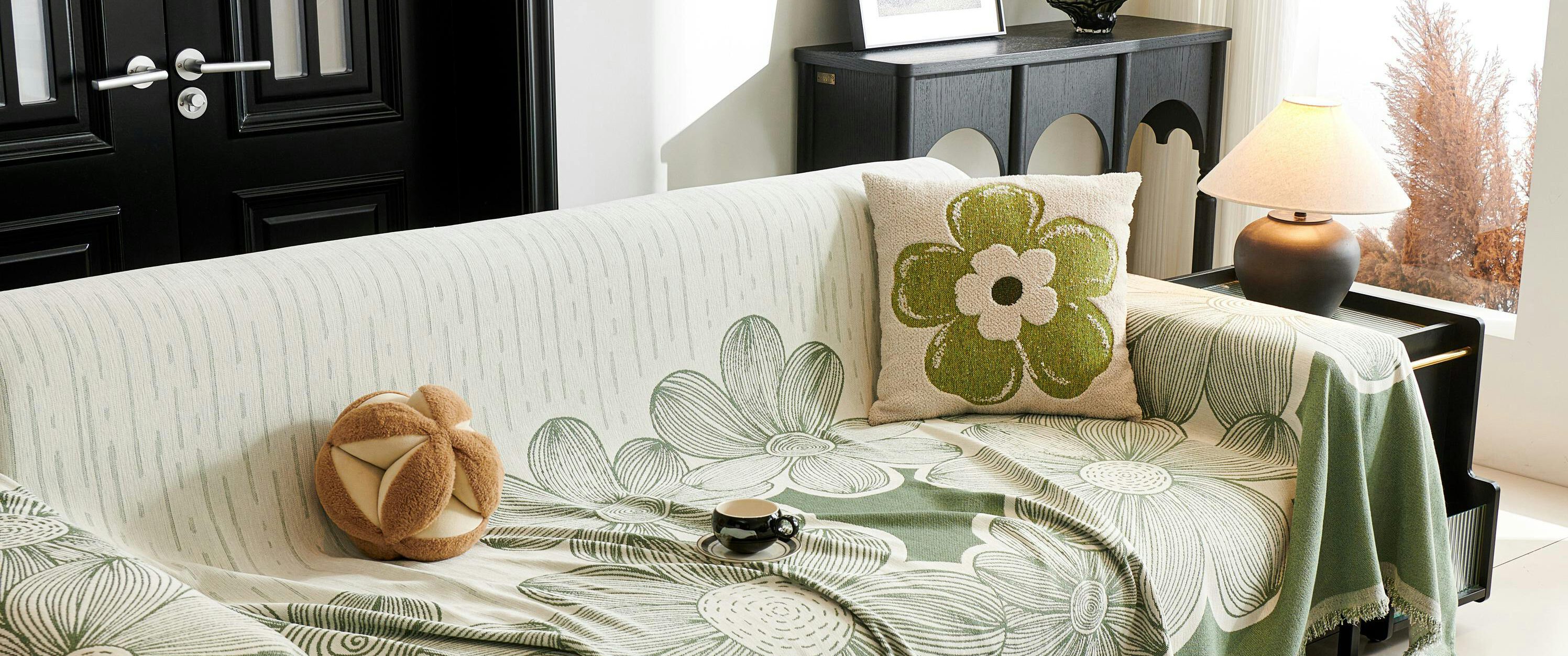 Stylish living room featuring a floral-themed sofa cover and chic decor accents.